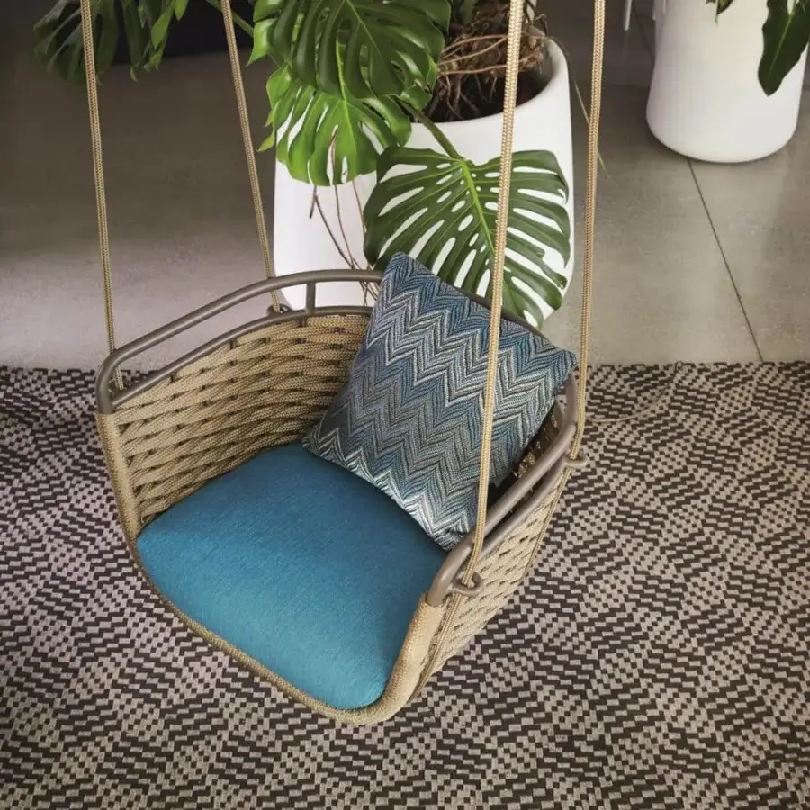 Superior Roberti Rattan Portofino swing built with aluminum and woven brown, tan Nautic Rope with teal cushion and chevron pillow