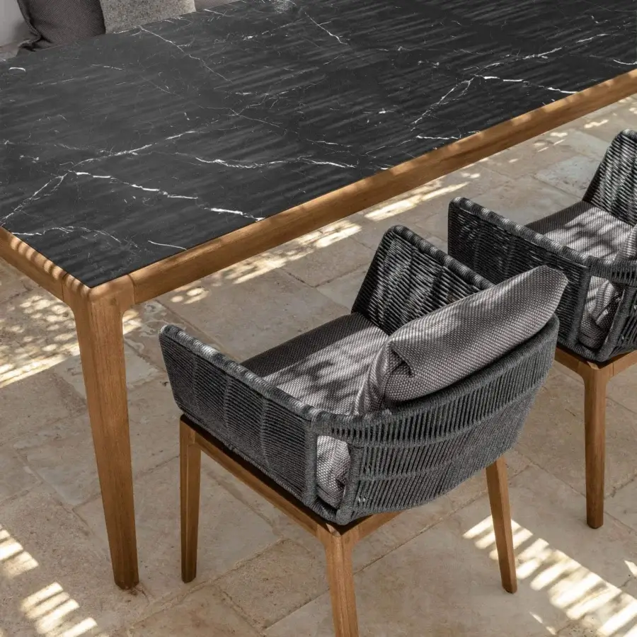 Elegant Talenti Cruise armchair with teak wood frame and dark gray woven material complemented by light gray cushions