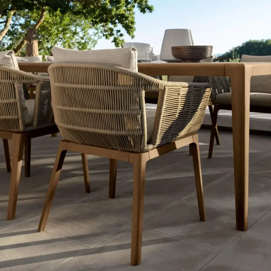 Exceptional Talenti Cruise armchair with teak wood structure and woven light-dark brown rope detailing, built with comfortable beige cushions