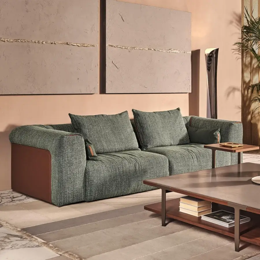 Stylish Turri Soul sofa upholstered in muted green textile with precious leather inserts framing brown panels