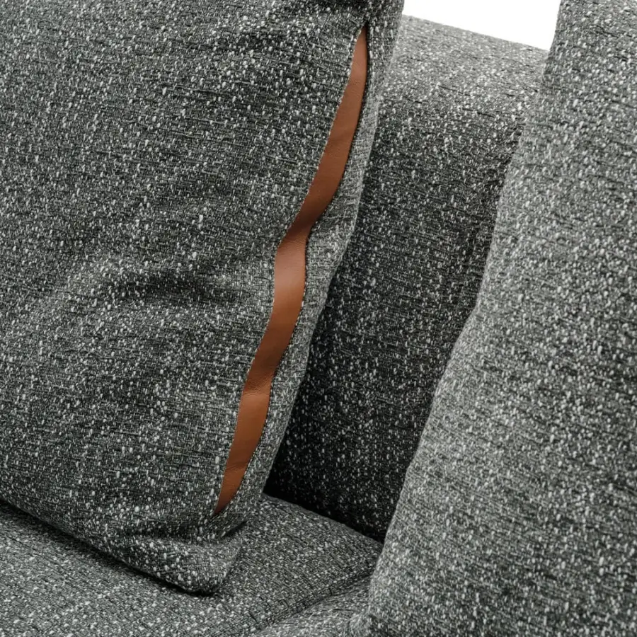 Elegant Turri Soul sofa built in textured gray fabric with woven appearance and brown material accents