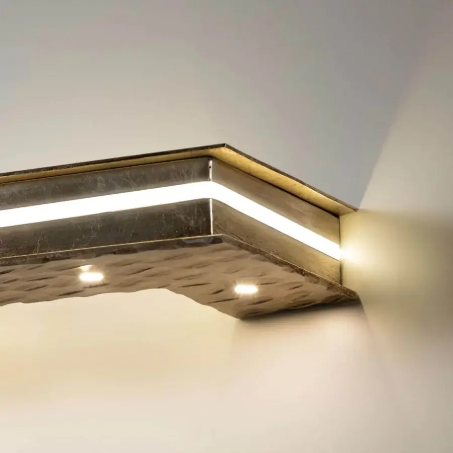 Captivating Stillux Otto wall lamp with geometric design crafted in textured gold-toned metallic material and integrated LEDs