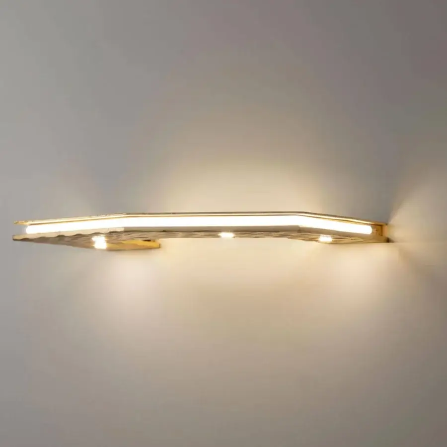 Exclusive Stillux Otto wall lamp with geometric half-octagonal form crafted in muted gold-toned hammered metal with integrated LEDs