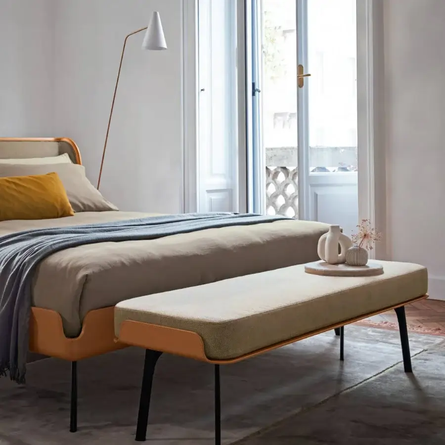 Superior Bolzan Letti Gabri bed with light brown textile upholstery, tan trim, and geometric grooves built upon dark legs