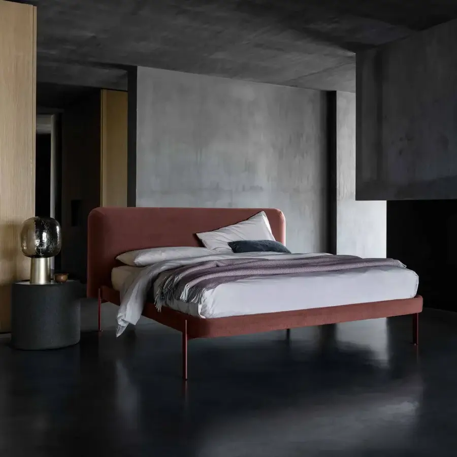 Captivating Bolzan Letti Joy bed with reddish-brown textile and firwood structure, built with geometric metallic legs and a rounded headboard