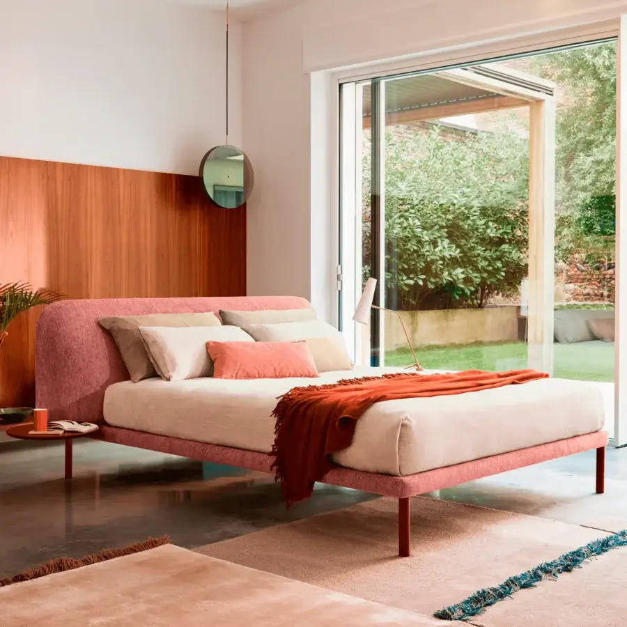 Exceptional Bolzan Letti Marty bed with soft pink textile upholstery, slender metal legs and durable firwood frame