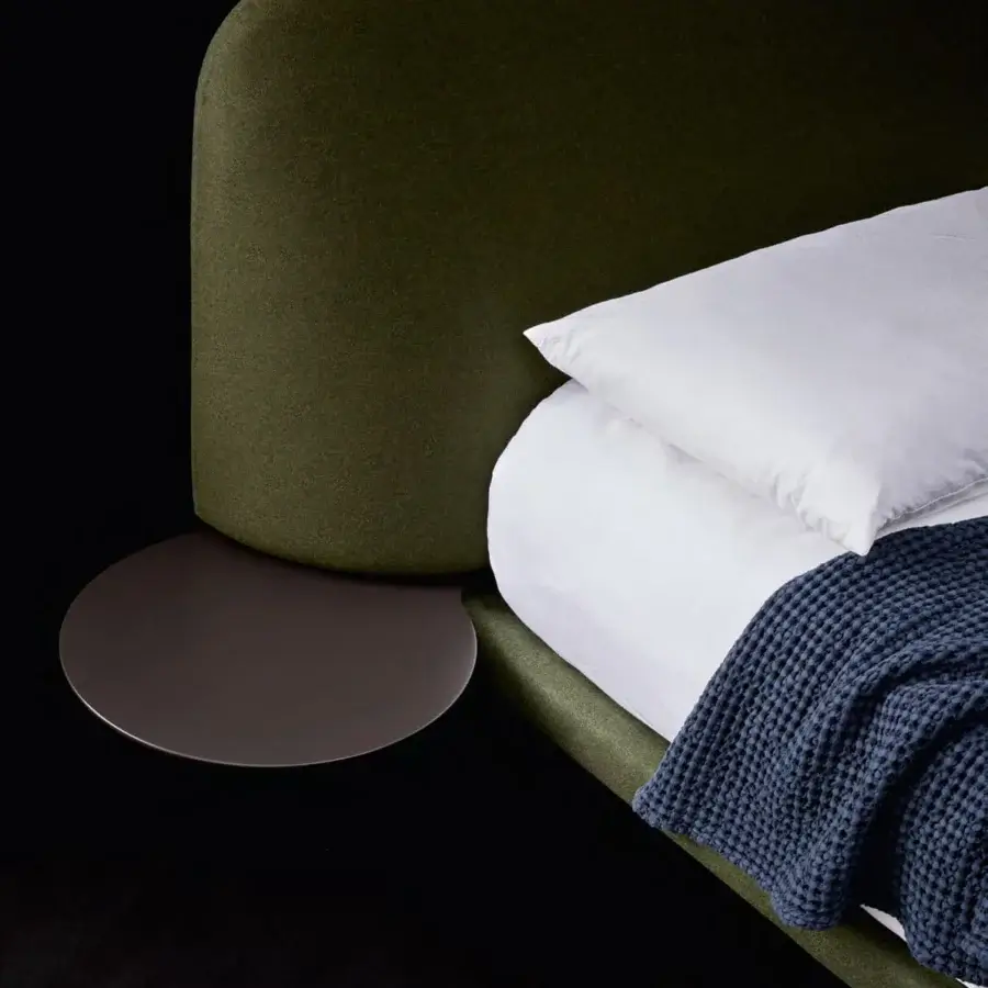Sophisticated Bolzan Letti Marty bed with dark olive green textile upholstery and dark brown circular side tray crafted with firwood structure