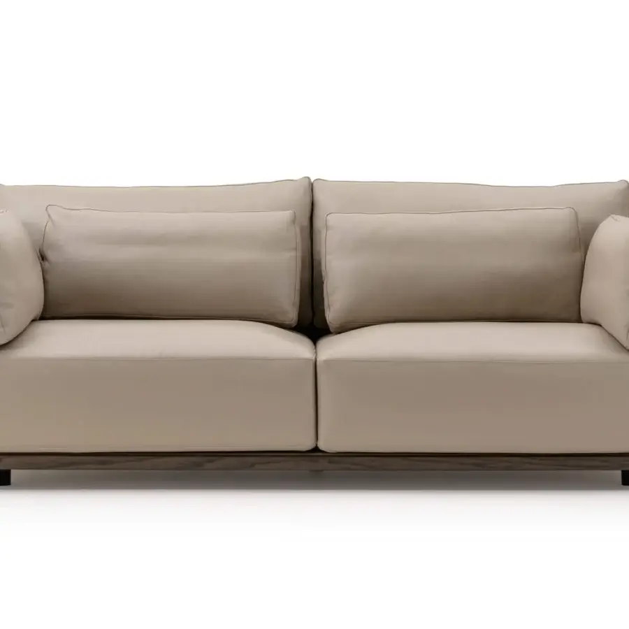 Sophisticated Turri Drum sofa with light beige upholstery and walnut wood accented with metal details in Italian leather panels