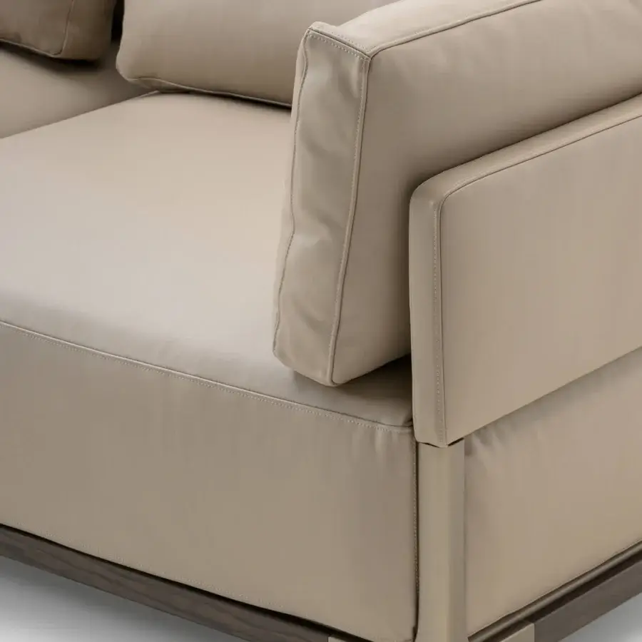 Sophisticated Turri Drum sofa with light beige leather cushions and walnut wood crafted with metal details