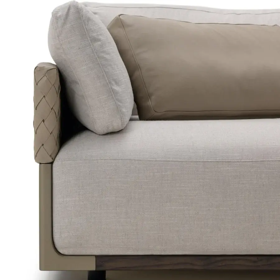 Distinguished Turri Drum sofa with comfortable light grey textile upholstery and woven tan leather armrests built with a dark wood plinth