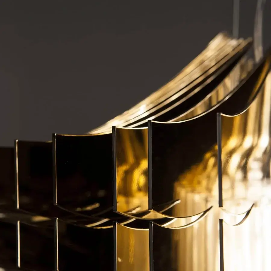 Lustrous Slamp Aria suspension lamp crafted in Cristalflex® with shining gold powder finish and sleek reflective surfaces