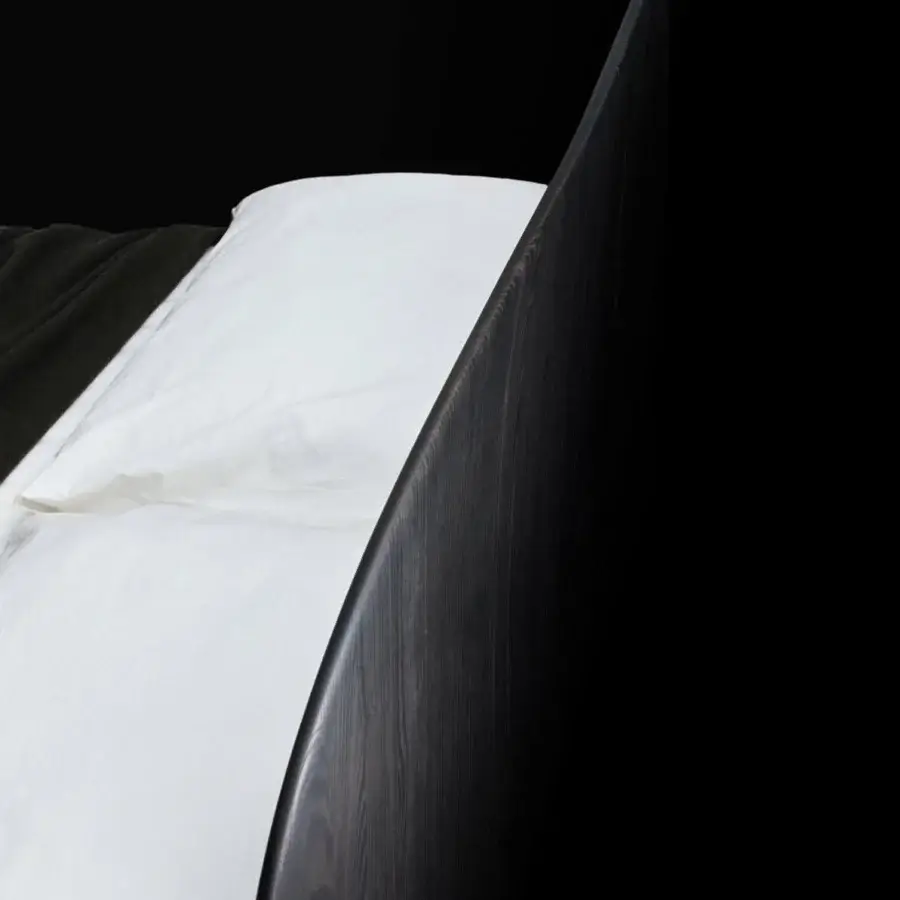 Distinguished Bolzan Letti Nest bed crafted with curving lines and a dark-stained rounded ash wood headboard against crisp white linens