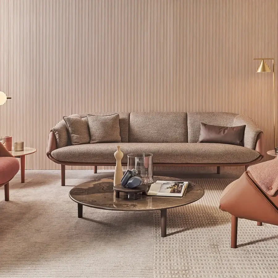 Innovative Turri Riban lounge chair with rose textile and reddish-brown leather upholstery showcasing visible seams