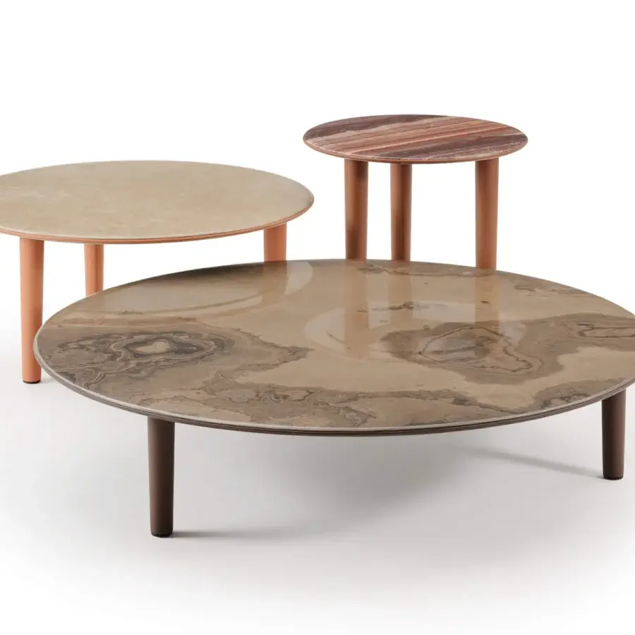 Elegant Turri Riban coffee tables with rounded lines, marble tops encircled by leather piping and cylindrical matte legs in beige, brown tones