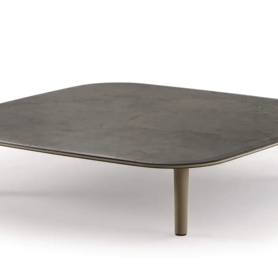 Elegant Turri Riban coffee table with organic form, mottled gray composite and light brown leather piping detail
