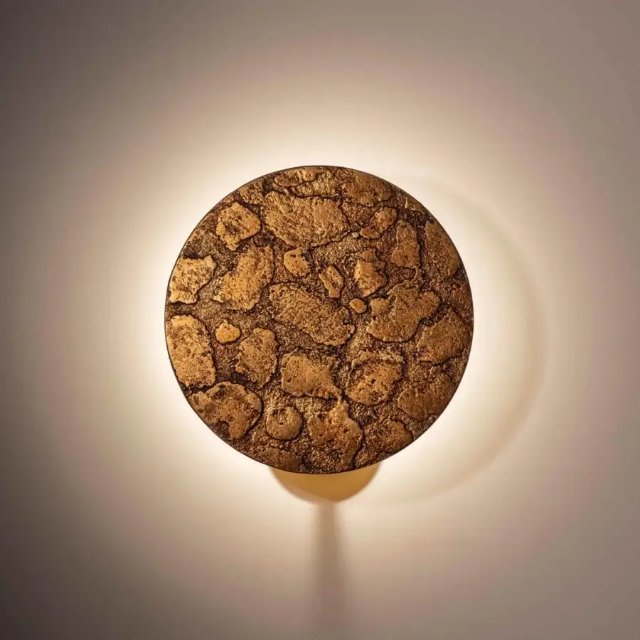 Exceptional Stillux Orbis wall lamp sculpted in earthy stone with a textured, irregular pattern and mix of browns and gold