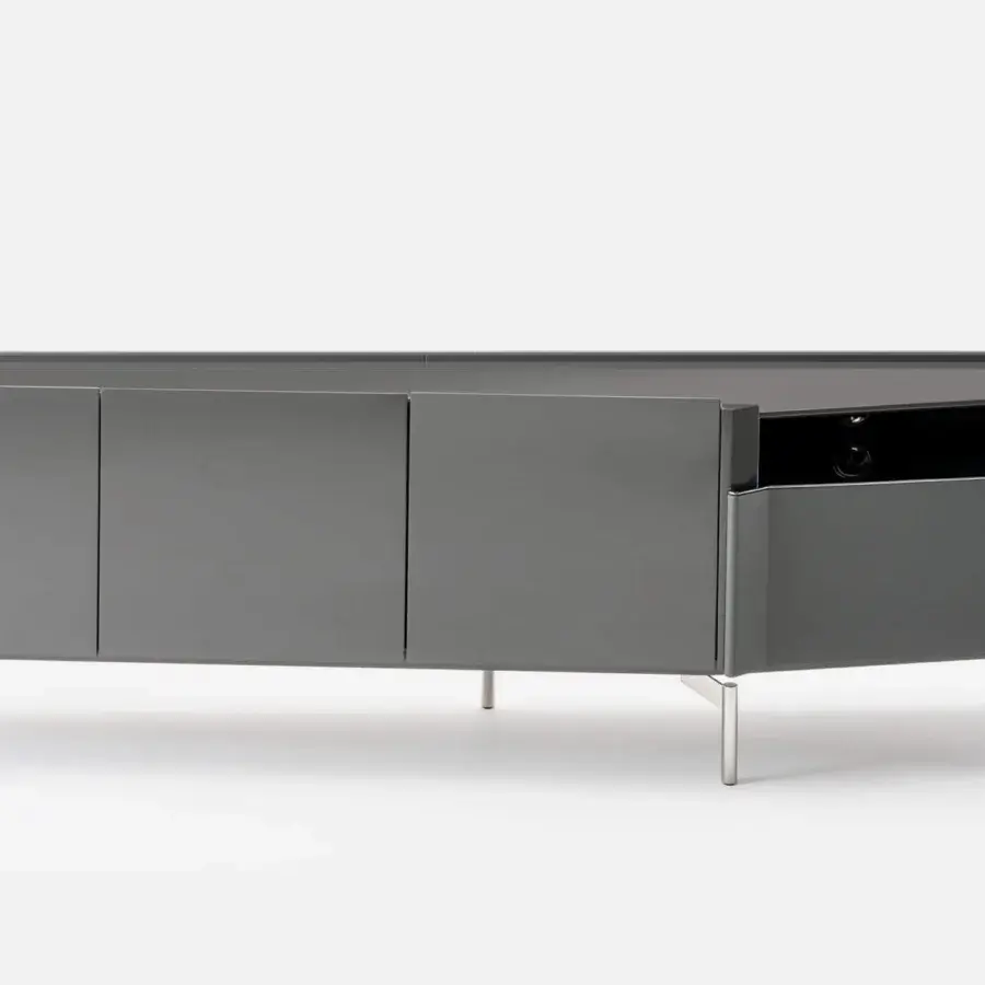 Innovative Turri Zenit TV stand in glossy lacquered wood with curved leather drawer and dark gray wooden top supported by light metal legs