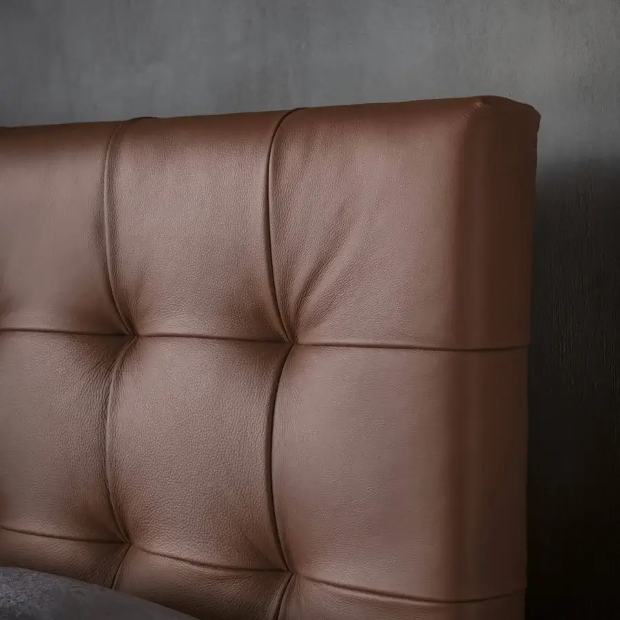 Distinguished Bolzan Letti Freedom bed with a captivating capitonné headboard crafted in medium brown leather-like material and visible seams