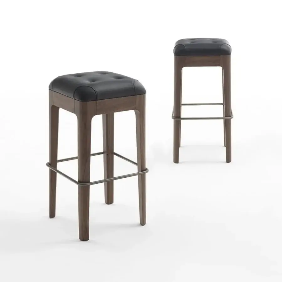Distinguished Porada Webby stool with capitonné black leather seat and solid canaletta walnut frame built with a stainless steel footrest