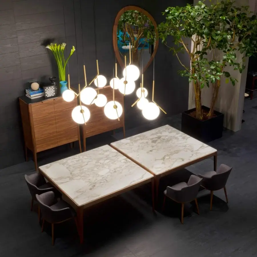 Distinguished Porada Ziggy table with light marble tabletop exhibiting gold and grey veining in solid Canaletto walnut construction