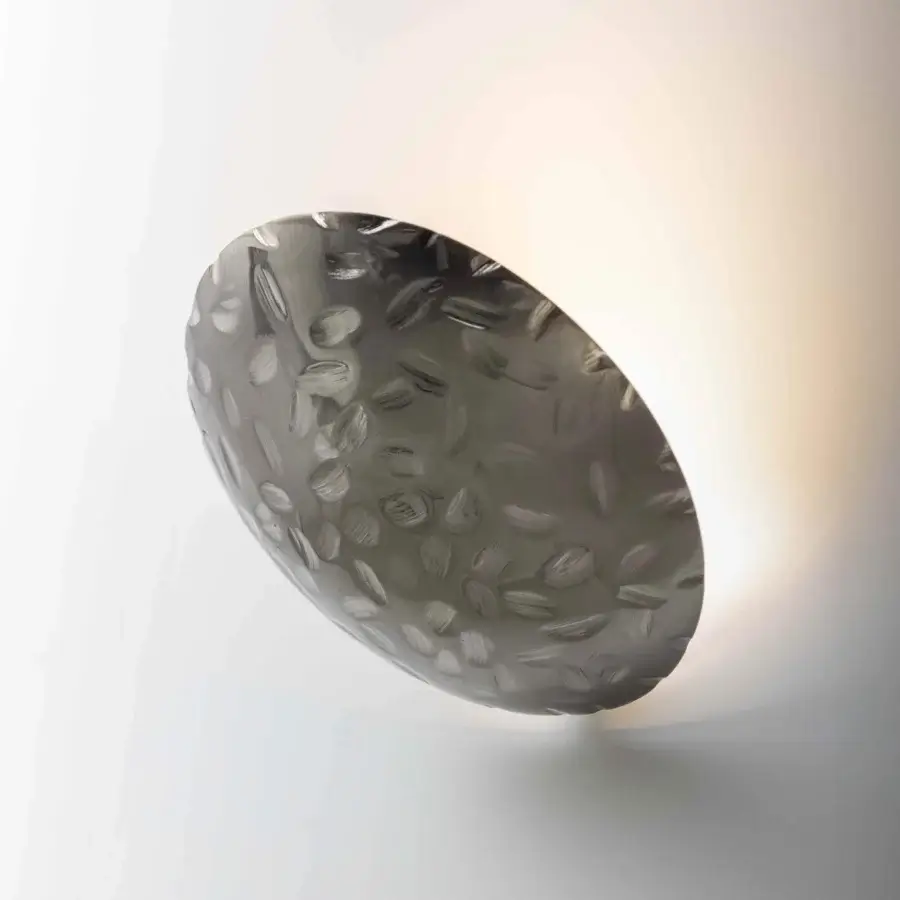 Distinguished Stillux Orbis wall lamp crafted in Italy with a muted gray hammered metal finish and concave form