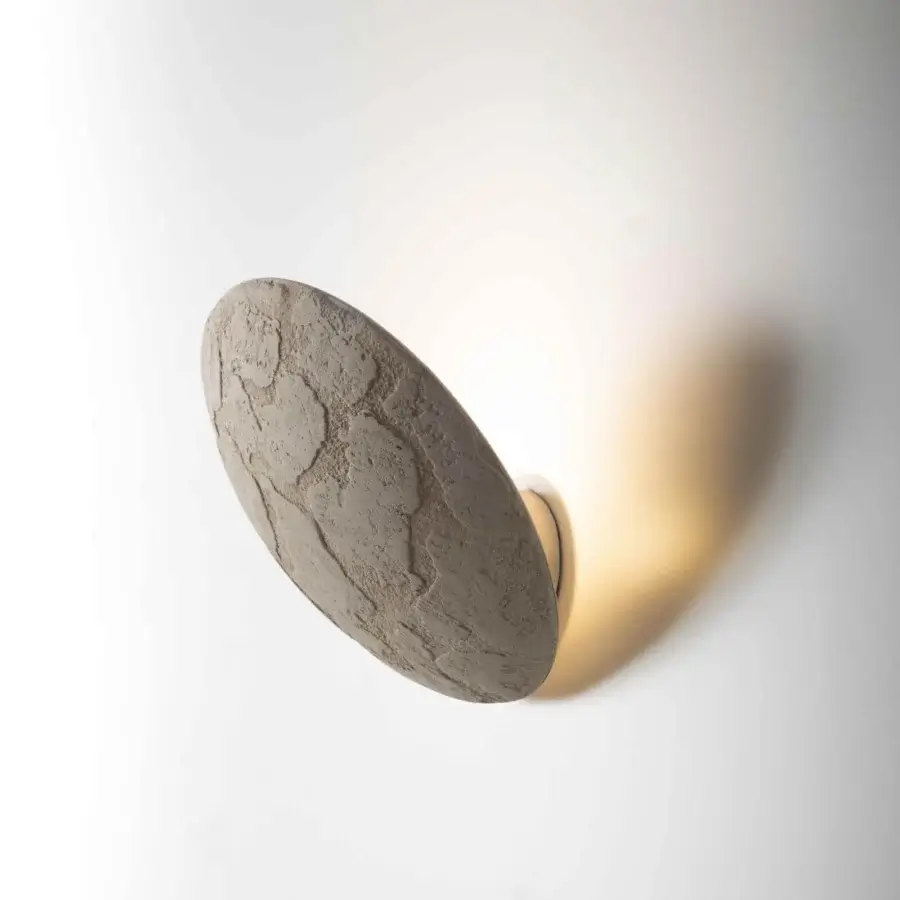 Innovative Stillux Orbis wall lamp crafted in Italy with a rustic stone appearance and muted gray tones