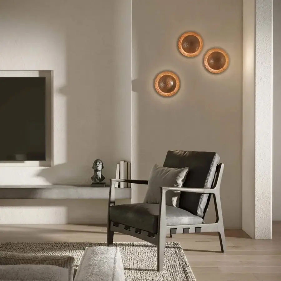 Elegant Stillux Orbis wall lamp crafted in warm copper tone with a rustic hammered metal surface