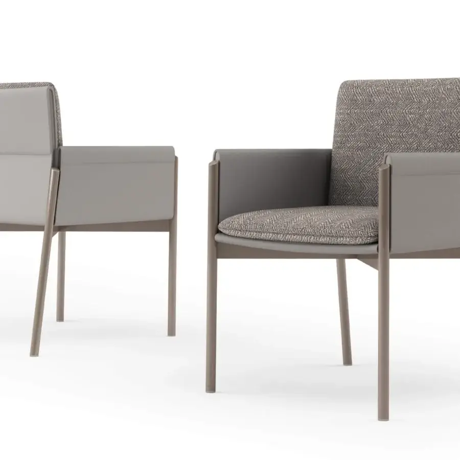 Sophisticated Turri Zenit armchair with light gray textile upholstery and a leather-clad frame built with thin metal legs