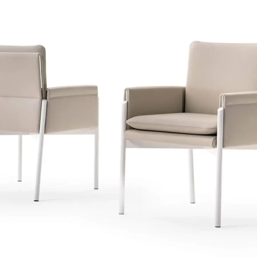 Exceptional Turri Zenit armchair with thin white metal legs and comfortable light beige fabric cushions
