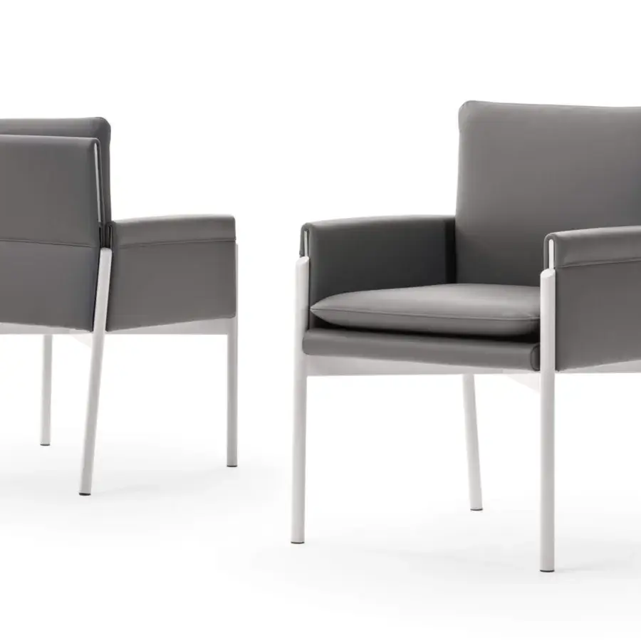 Sophisticated Turri Zenit armchair with matte white metal legs and comfortable gray textile cushions in leather upholstery