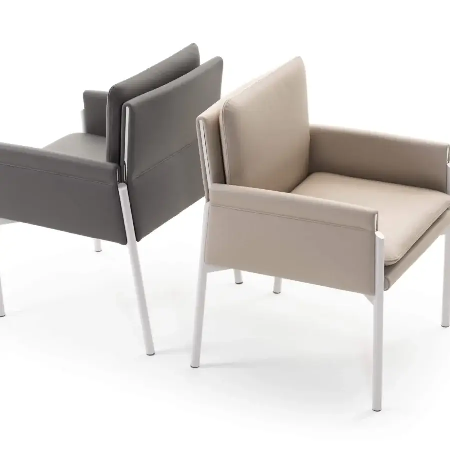 Exclusive Turri Zenit armchair with thin metal legs and comfortable cushions clad in light beige textile