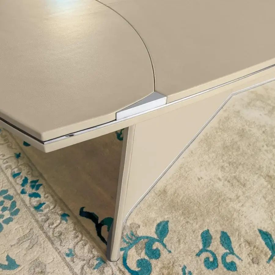 Superior Mascheroni Prior table with multilayer wood and aluminum panel top, a curved plywood base with steel accents and smooth beige finish