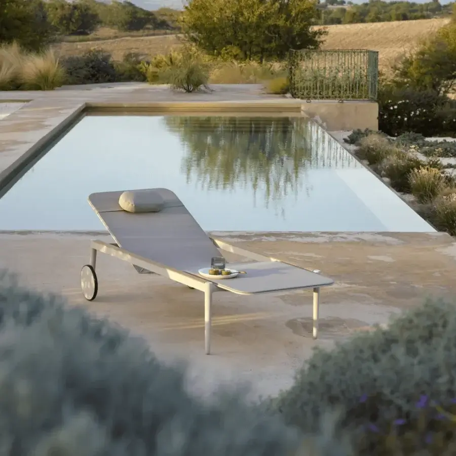 Superior Royal Botania Styletto lounger with light gray textile seating and powder-coated metal frame built with integrated wheels