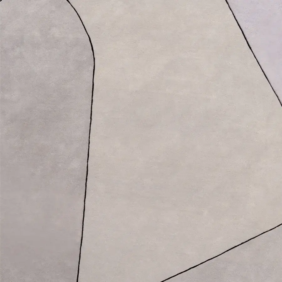 Lavish Turri Zenit rug with teardrop silhouette, intersecting lines in tonal grays and lilac, hand-knotted wool finish