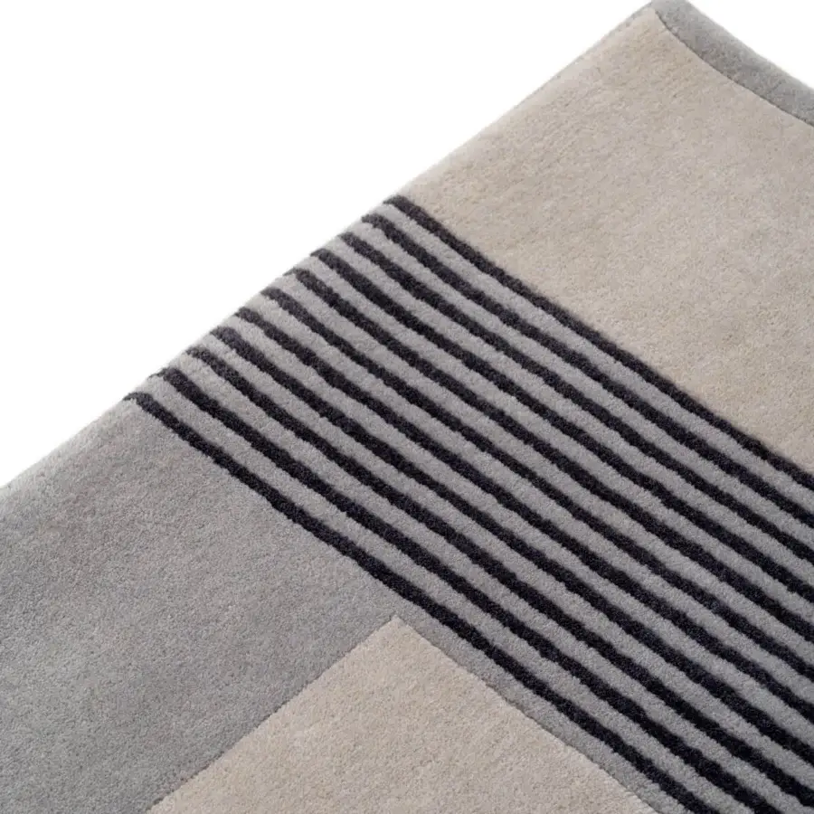 Exceptional Turri Zenit rug presents a contemporary geometric striped pattern hand-knotted in 100% wool with a matte finish