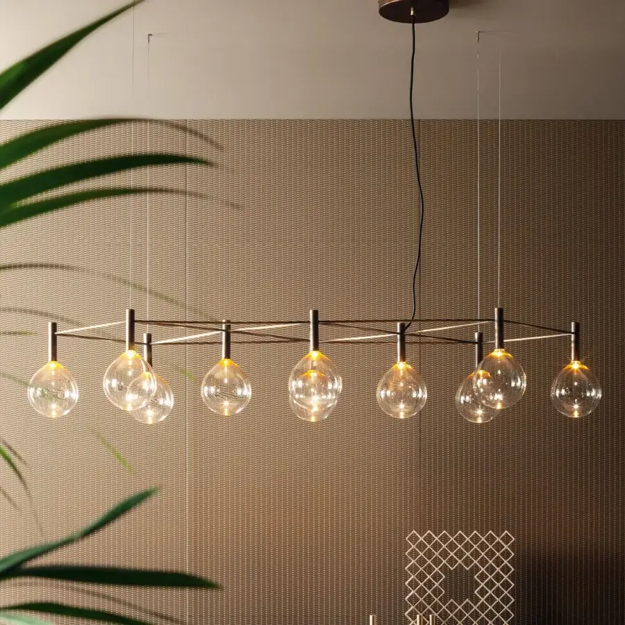 Refined Bonaldo Sofi suspension lamp with warm amber borosilicate glass globes and burnished brass cylinder supporting clear glass spheres