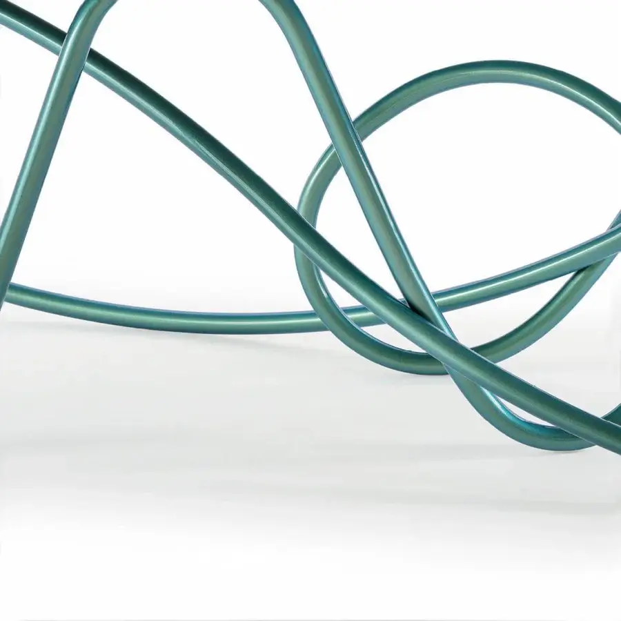 Elegant Turri Azul table with sinuous iridescent teal base and refined marble shaped tabletop crafted with liquid painted metal