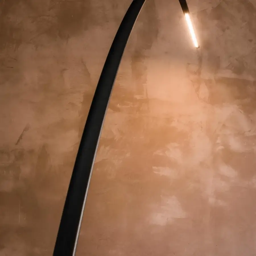 Elegant Cattelan Italia Lampo floor lamp with a curved frame in black embossed lacquered steel and golden LED light