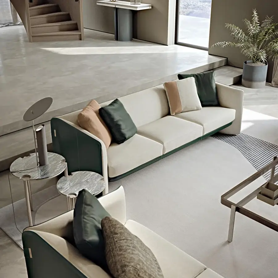 Distinguished Turri Blossom sofa with light beige textile upholstery and a smooth dark green synthetic frame