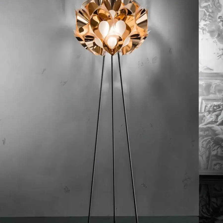 Innovative Slamp Flora floor lamp with sixty petals surrounding a satin sphere in glossy golden aluminum and matte black legs