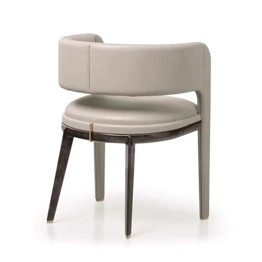 Elegant Turri Eclipse armchair with light gray upholstery, dark wood legs crafted with gold metal details