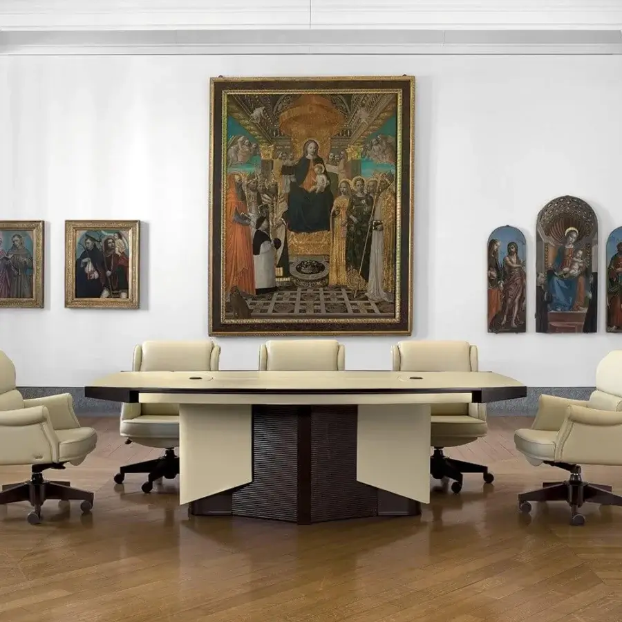 Distinguished Mascheroni Planet conference table built with light-colored wood and a dark, vertically-lined base with natural leather accents