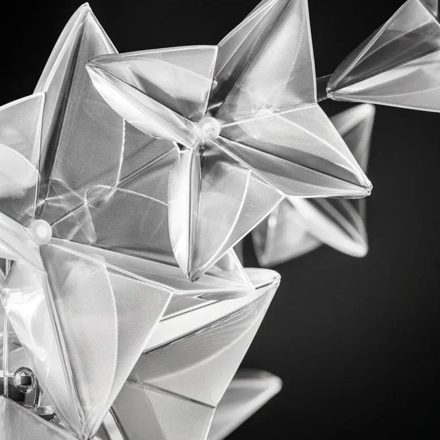 Distinguished Slamp Hanami suspension lamp crafted in clear translucent Lentiflex® recreating diamond-like reflections with interconnected star-shaped elements