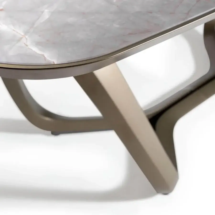 Elegant Reflex Segno table with light gray marble glass top and satin bronze finished angular metal legs