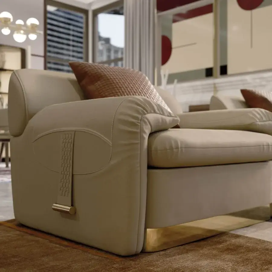 Distinguished Turri Eclipse lounge chair with sinuous lines, folded armrests and uniform beige leather upholstery with a light gold metal base