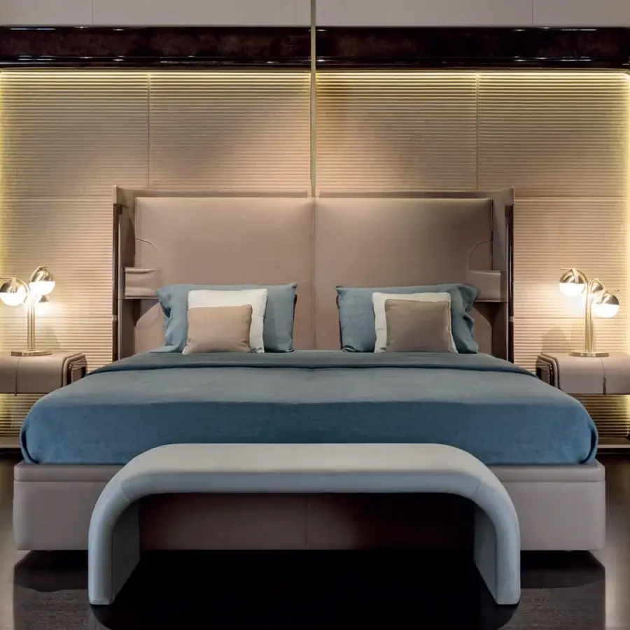 Elegant Turri Eclipse bench upholstered in light grey fabric with gold metal detail and uniform matte finish