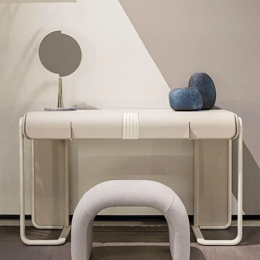 Sophisticated Turri Eclipse ottoman with light gray fabric upholstery and gold metal accent