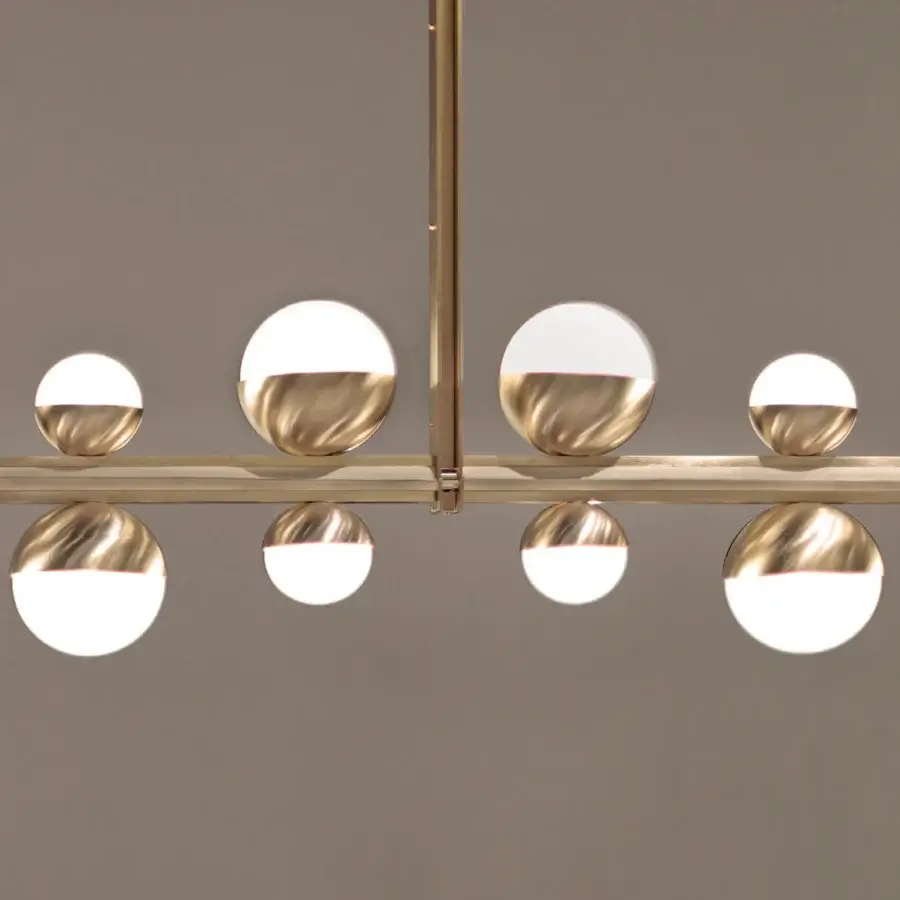 Elegant Turri Eclipse suspension lamp with a linear satin bronze metal structure and opaque white spheres