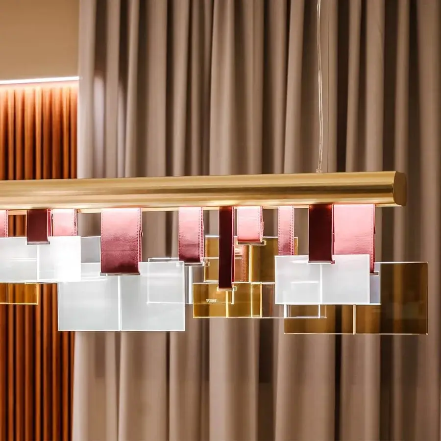 Distinguished Turri Eclipse suspension lamp with golden metal, clear glass elements and reddish-brown leather straps exhibiting a lustrous finish