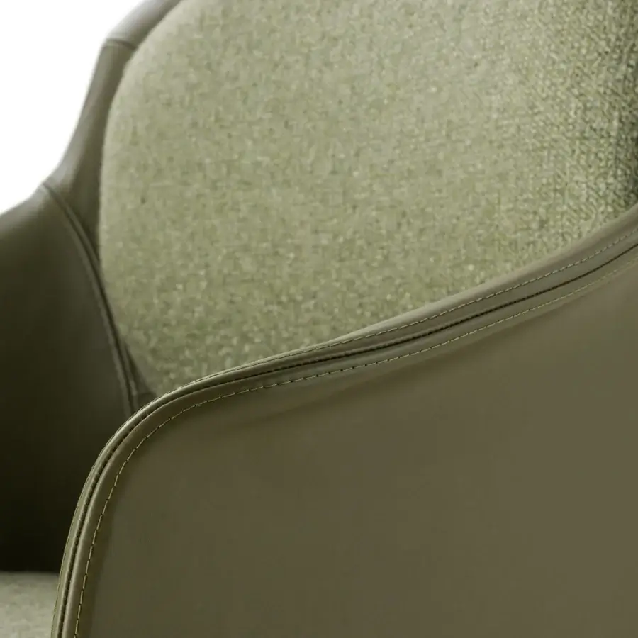 Distinctive Turri Echo armchair with olive green leather shell and gracefully curved arm, in textured textile backrest cushion